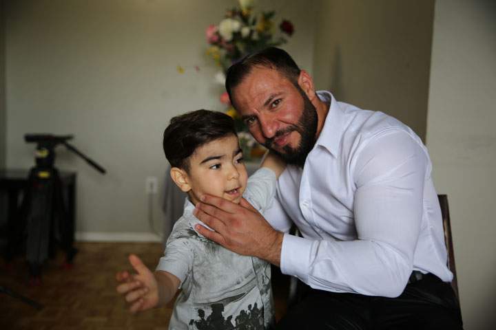 Mohammed Alkarad and his young son in their apartment in Ottawa.