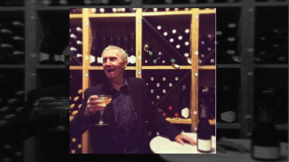 Former bank robber Boyne Johnston is seen smiling and holding a glass of champagne in Riviera's wine cellar on Friday, Aug. 10, 2018.