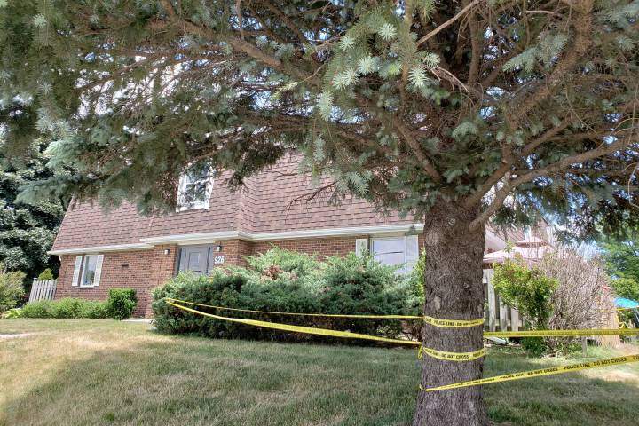 Police tape can be seen cordoning off an area of the townhouse complex on Courtland Avenue.

