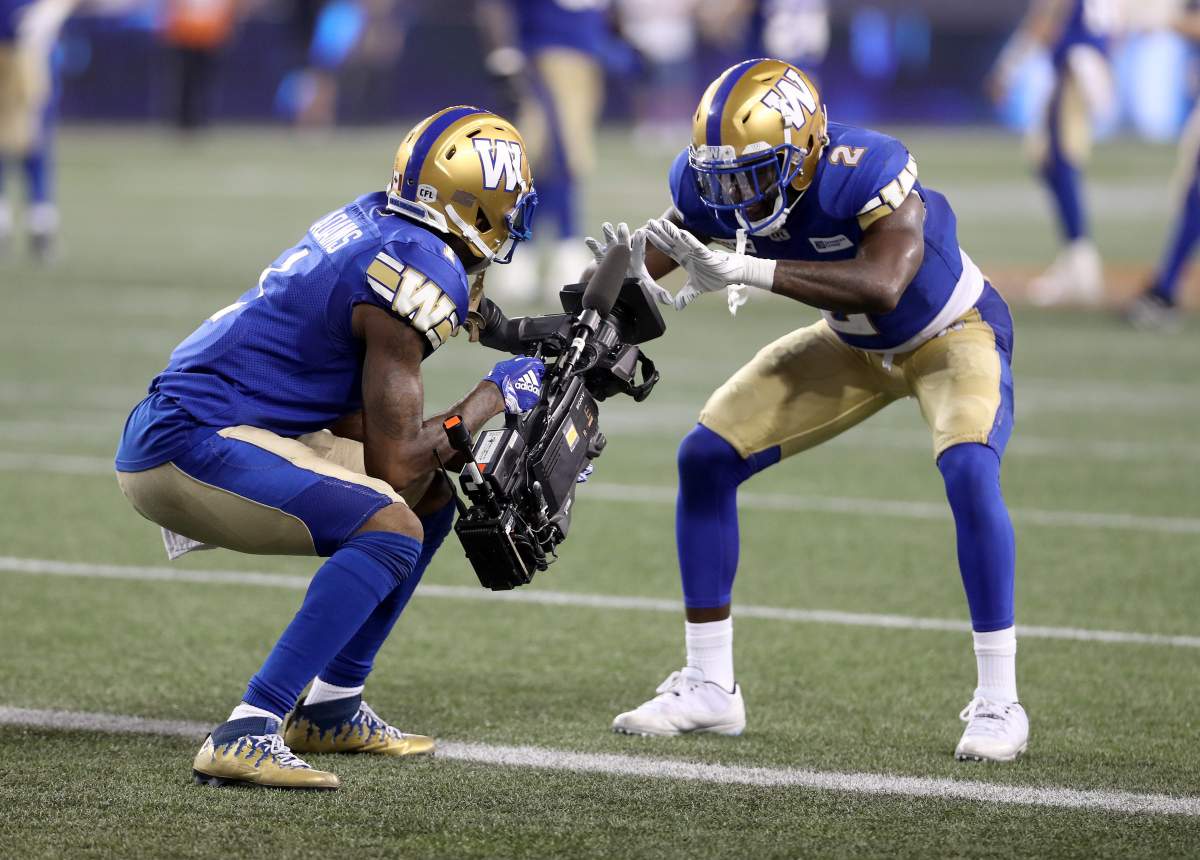 Winnipeg Blue Bombers’ Darvin Adams (1) and Kenbrell Thompkins (2) celebrate after Adams scored a touchdown in the fourth quarter against the Ottawa Redblacks in Winnipeg on Friday, August 17, 2018.