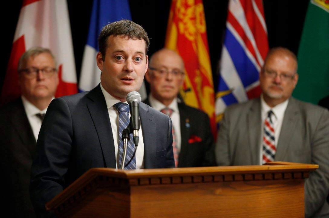 Randy Delorey, Nova Scotia Minister of Health and Wellness, responds to a reporter's questions as from left, Gaetan Barrette, Quebec Minister of Health and Social Services, John Haggie, Newfoundland and Labrador Minister of Health and Community Services, and Kelvin Goertzen, Manitoba Minister of Health, Seniors and Active Living listen in at a press conference during the Conferences of Provincial-Territorial Ministers of Health in Winnipeg, Thursday, June 28, 2018. 