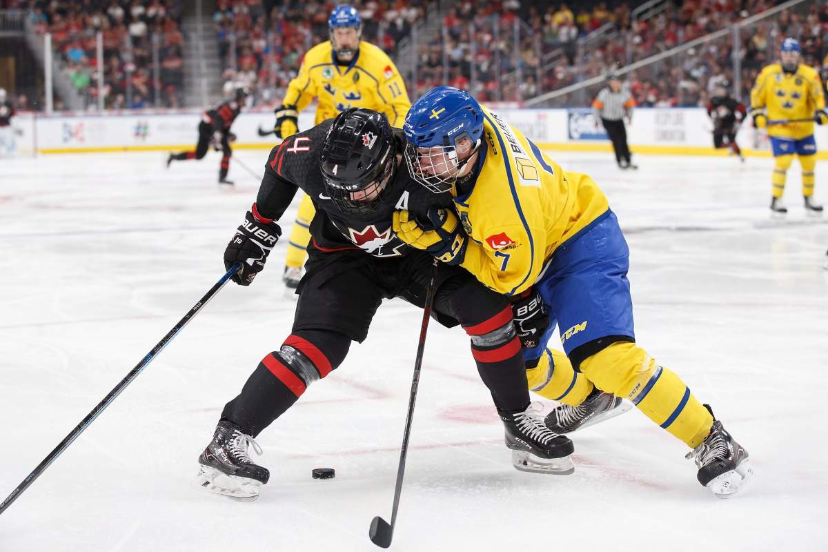 Canada's Bowen Byram (4) battles against Sweden's Tobias Bjornfot (7) during third period Hlinka Gretzky Cup action in Edmonton on Wednesday, August 8, 2018. Canada won 4-3. 