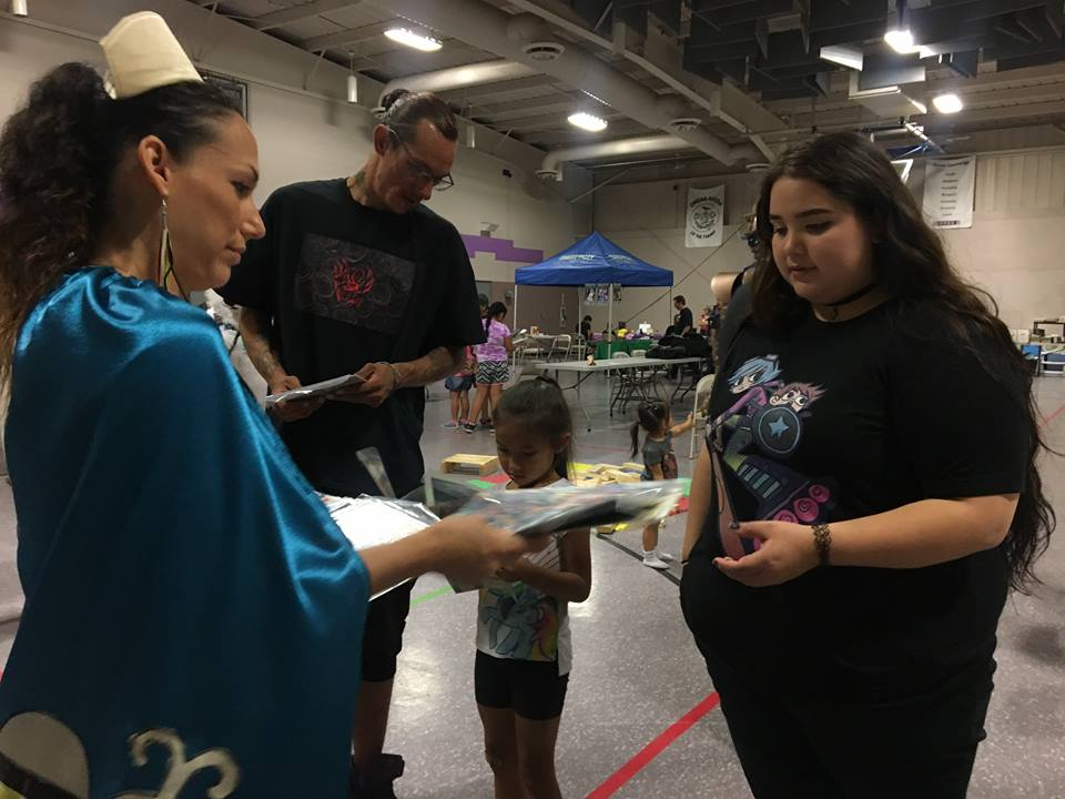 Nurse Hope signs an autograph at the inaugural "Indigi-Con.".