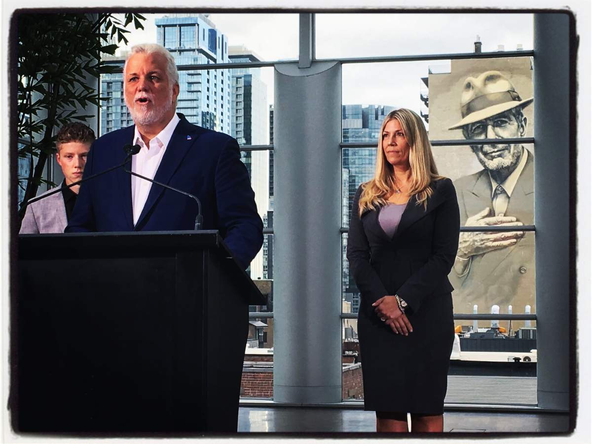 Premier Philippe Couillard, centre, introduces new Liberal party candidate for Westmount – St-Louis Jennifer Maccarone, left. (Global News / Phil Carpenter)