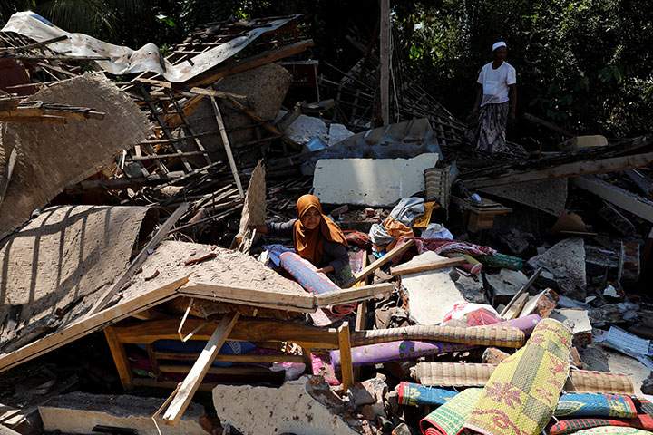 Villagers try to find valuables from the ruins of their house at Kayangan district after earthquake hit on Sunday in North Lombok, Indonesia, August 7, 2018.