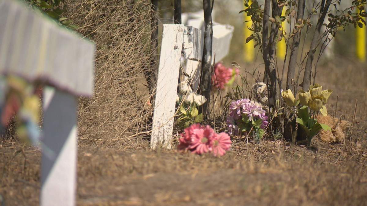 The Regina Indian Industrial School cemetery fence is adorned with flowers, ribbons and stuffed animals in memory of the children buried here.