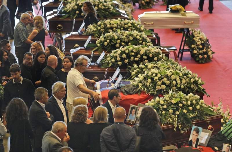 NonePeople arrive to attend a funeral service for some of the victims of a collapsed highway bridge in Genoa, Italy, Saturday, Aug. 18, 2018. Saturday has been declared a national day of mourning in Italy and includes a state funeral at the industrial port city’s fair grounds for those who plunged to their deaths as the 45-meter (150-foot) tall Morandi Bridge gave way Tuesday.