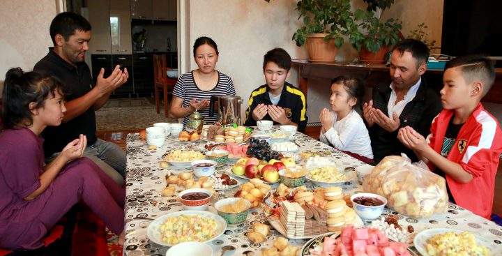 A Kyrgyz family prays during Eid al-Adha celebrations in the village of Kok-Jare outside Bishkek, Kyrgyzstan, 21 August 2018.