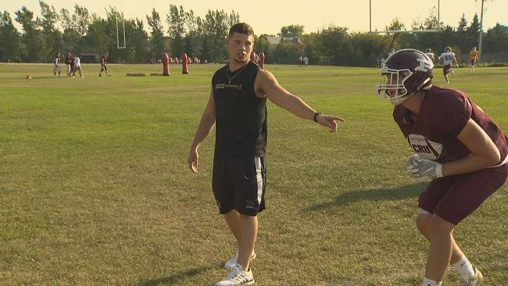 St. Paul's Crusaders linebackers coach DJ Lalama gives players instructions.