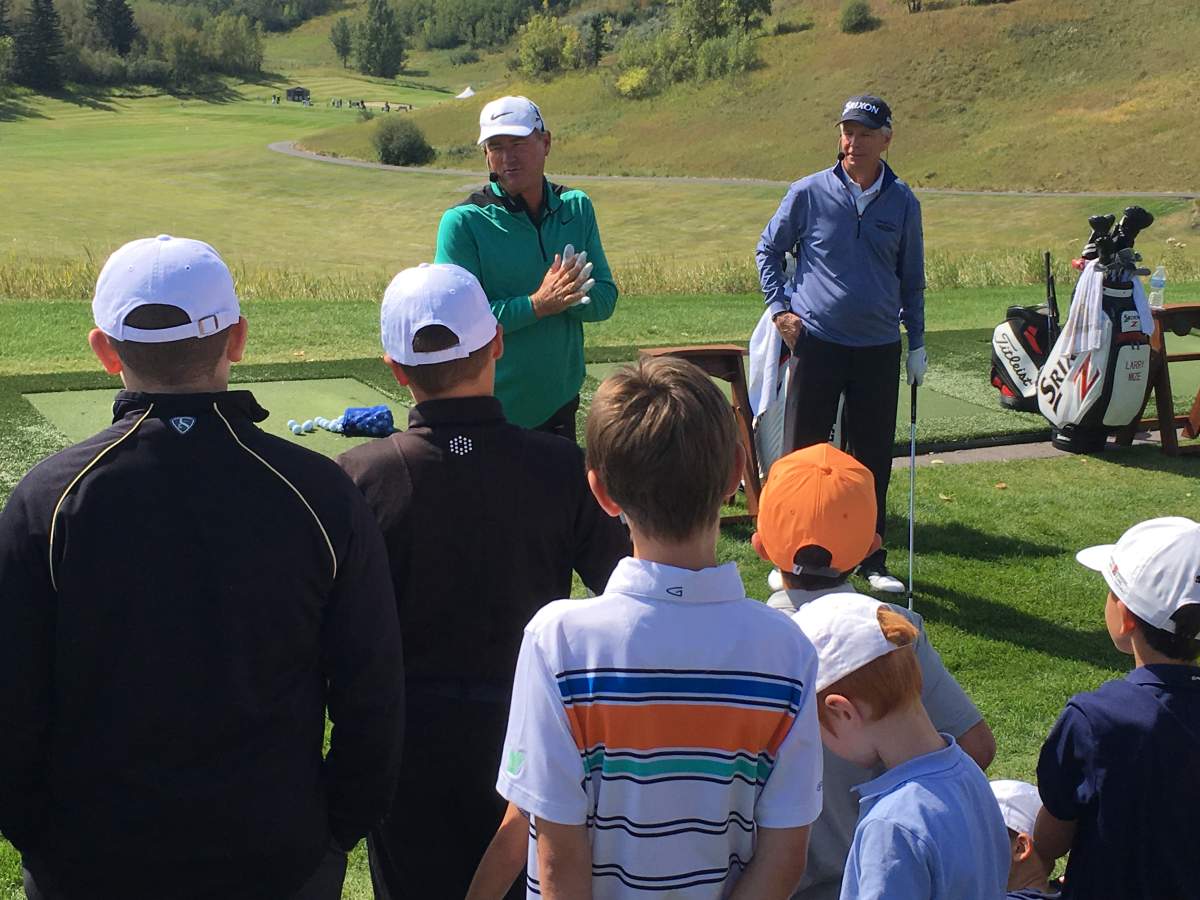 Larry Mize and Brian Mogg trach the game of golf to juniors at Canyon Meadows Golf Club in Calgary. Aug. 28, 2018.
