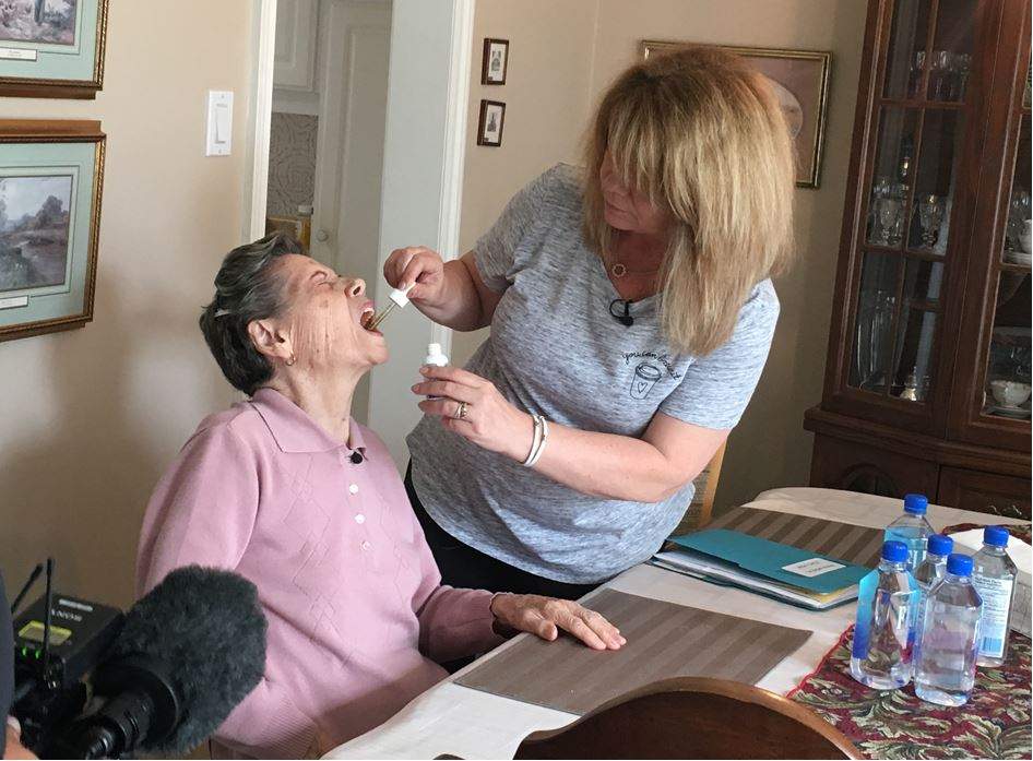 Linda Moreal giving her mother, Maria Moreal, her cannabinoid oil medication.