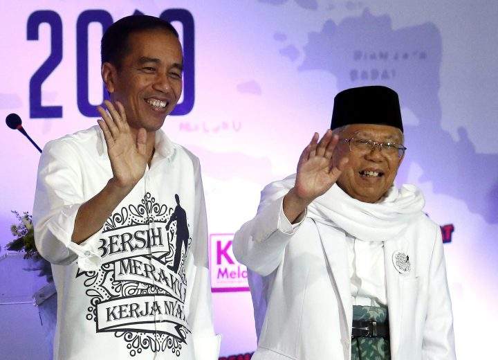 Indonesian incumbent presidential candidate Joko Widodo, left, and his running mate KH Ma’ruf Amin wave after they register for the 2019 presidential election at the General Election Commission office in Jakarta, Indonesia, on Aug. 10, 2018.