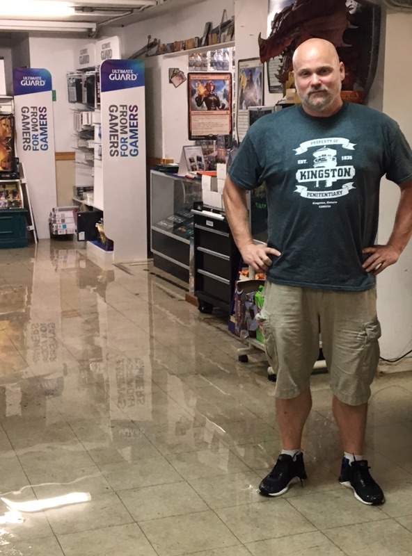 Kingston Gaming Nexus store owner Michael Wibberly stands in his store, that flooded due to the heavy rain on Wednesday.