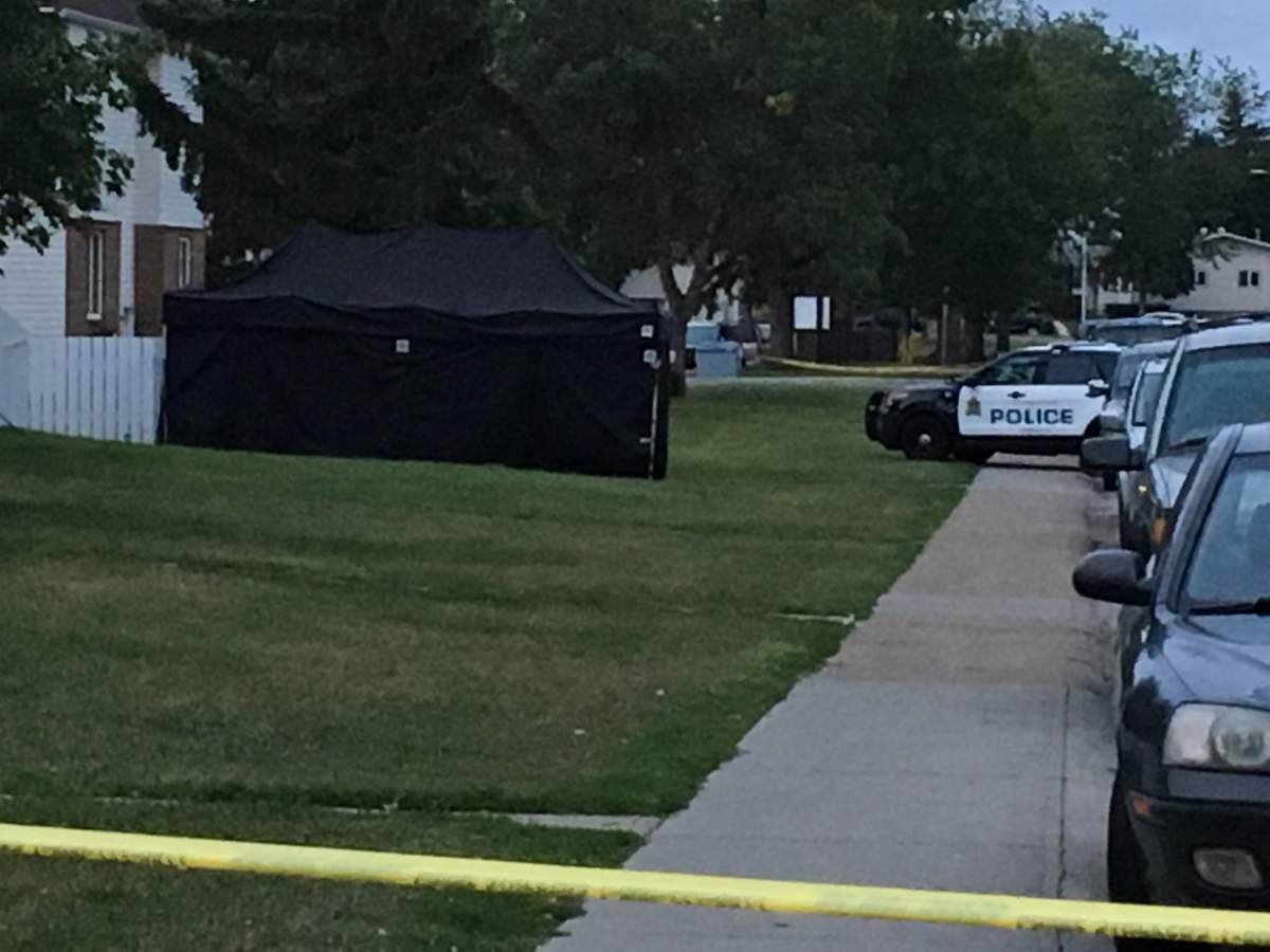 Edmonton Police Service officers investigating at the Parkview Estates rental complex, at 116a Avenue and 32 Street, in the Rundle Heights neighbourhood. A black tent was set up in front of a row of townhomes. Monday, August 27, 2018.