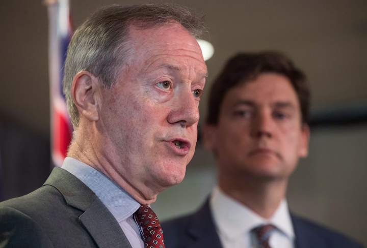 Peter German, front left, former deputy commissioner of the RCMP, speaks about his review of anti-money laundering practices in the province as B.C. Attorney General David Eby listens during a news conference, in Vancouver, on Wednesday June 27, 2018.