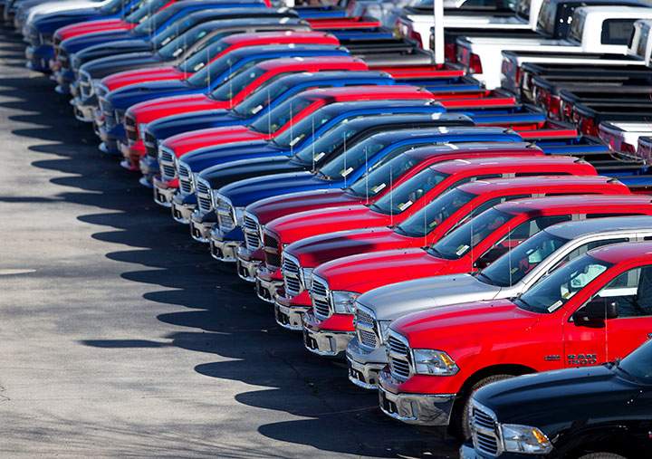 In this Jan. 5, 201, file photo, Ram pickup trucks are on display on the lot at Landmark Dodge Chrysler Jeep RAM in Morrow, Ga. 