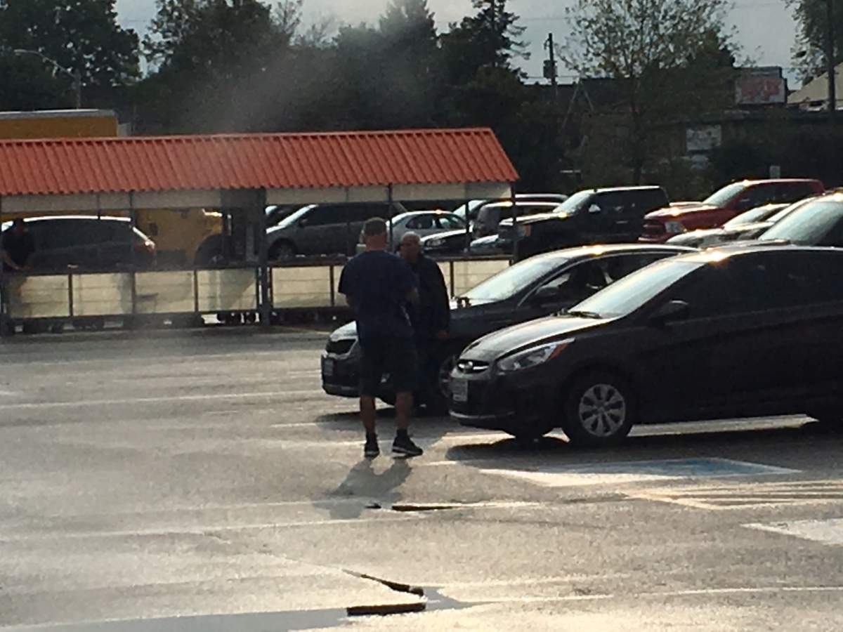A witness says a man (facing) shot a woman in the parking lot of The Home Depot in Peterborough on Wednesday morning.