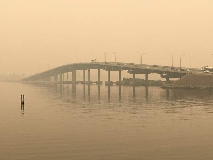 Heavy wildfire smoke surrounds the William R. Bennett Bridge connecting Kelowna to West Kelowna on Saturday, August 18, 2018.