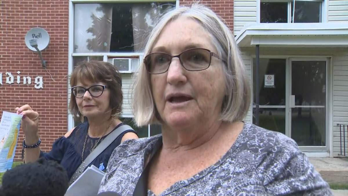 Suzanne Webster is one of the volunteers handing out brochures to tenants that list mental health resources available to them.