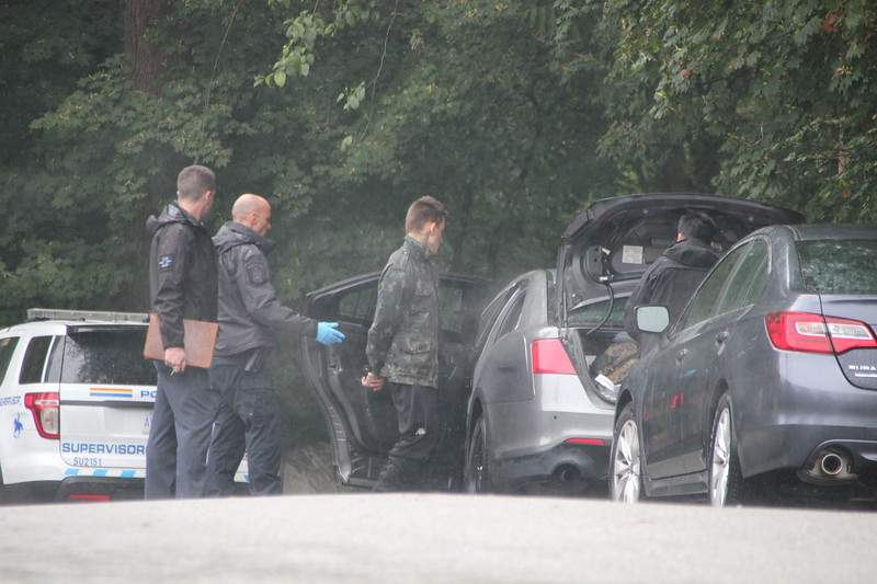 A man is seen being taken into police custody after an alleged assault Saturday morning. 