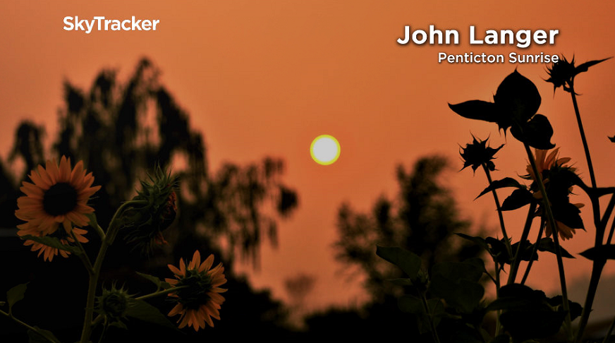 Thick smoke creatan orange hue at sunrise in Penticton.