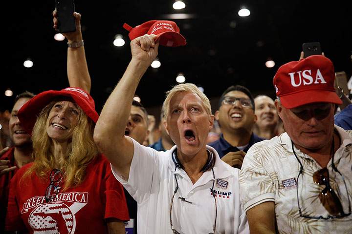 Supports react as U.S. President Donald Trump is introduced at the Make America Great Again Rally at the Florida State Fairgrounds in Tampa, July 31, 2018.
