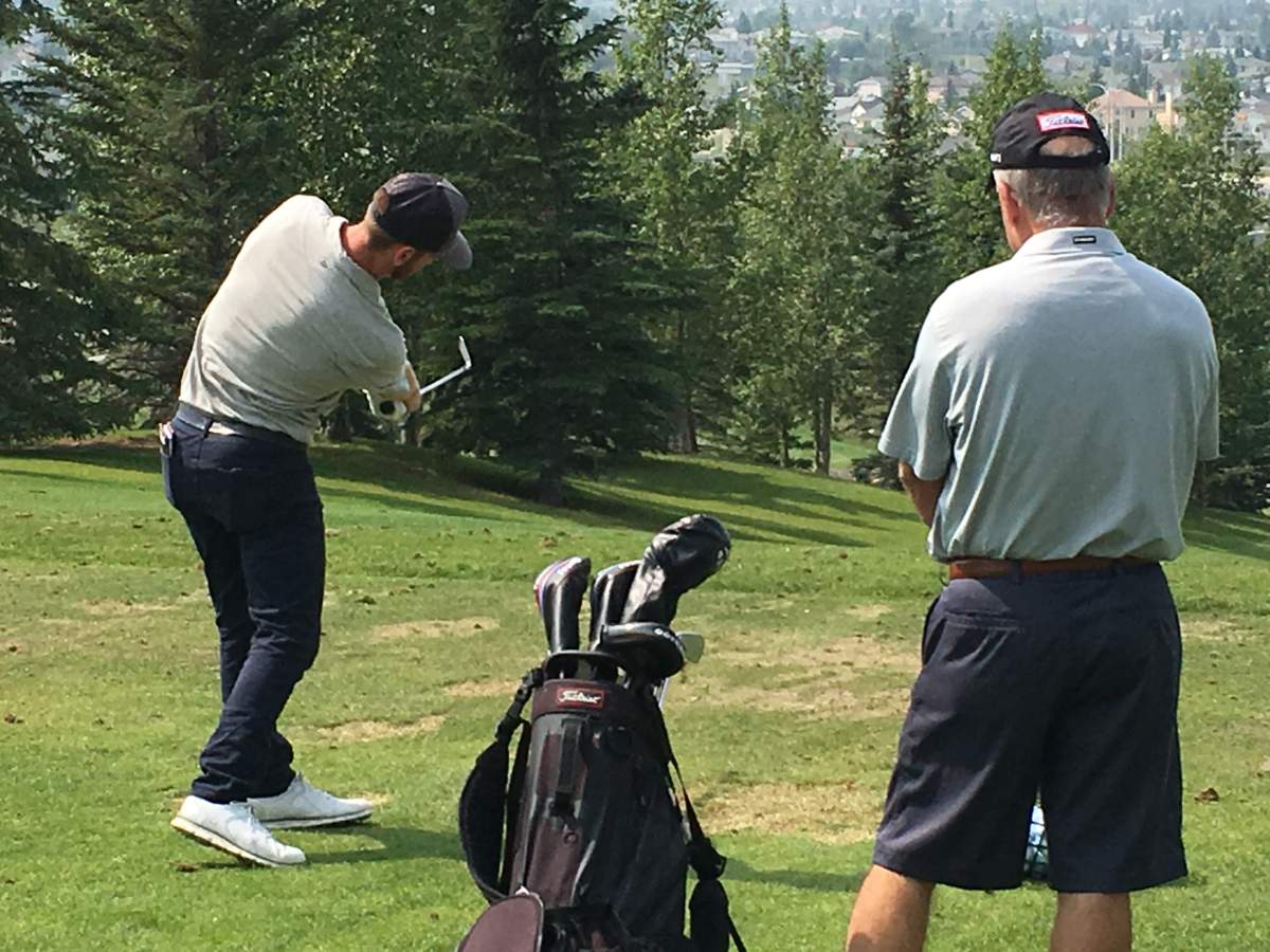 Tyler and Mark McCumber on the driving range at Country Hills in Calgary on Aug. 7, 2018.
