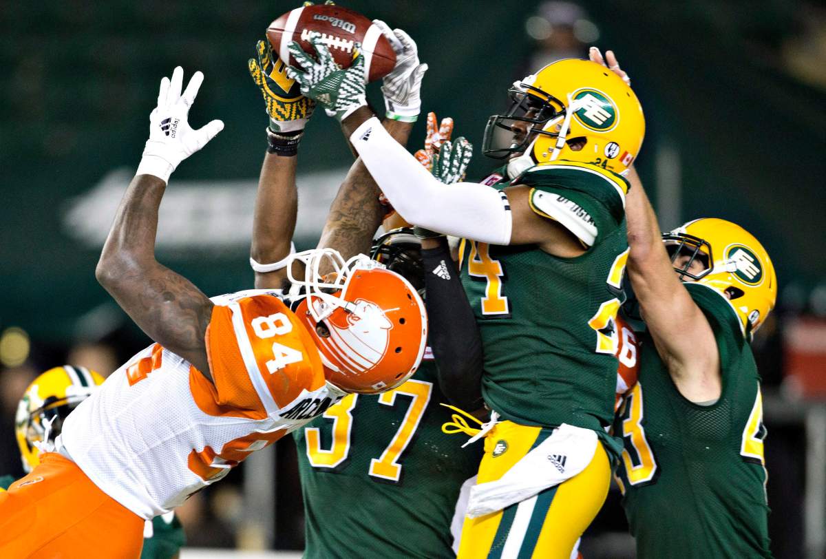 B.C. Lions' Emmanuel Arceneaux (84) tries to get the pass as Edmonton Eskimos Brandyn Thompson (24) makes the interception during second half CFL action in Edmonton, Alta., on Friday September 23, 2016. 