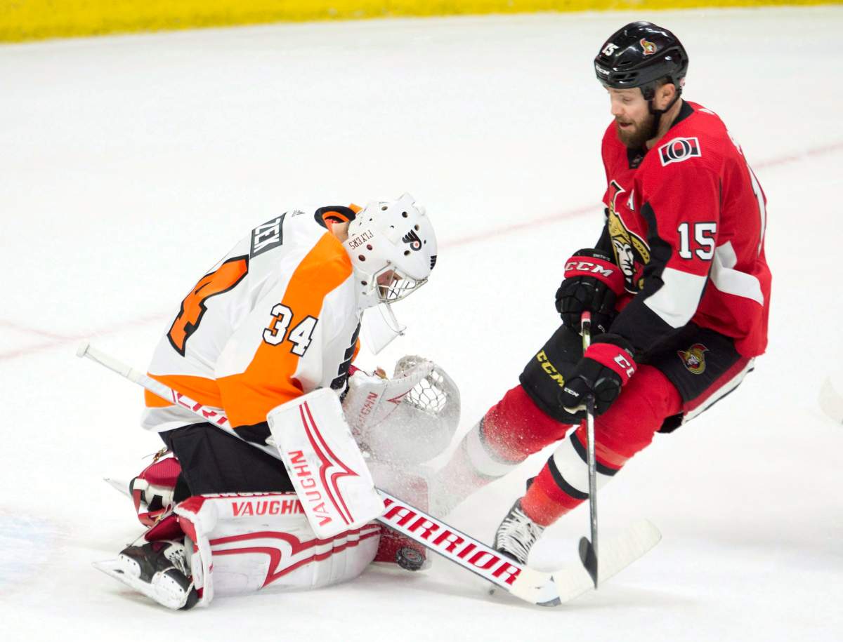 Ottawa Senators left wing Zack Smith pressures Philadelphia Flyers goaltender Petr Mrazek as he tries to control a shot during first period NHL action Saturday February 24, 2018 in Ottawa. 
