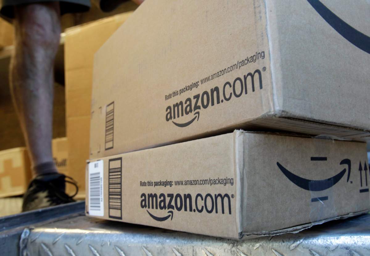 In this June 30, 2011, file photo, a United Parcel Service driver delivers packages from Amazon.com in Palo Alto, Calif.