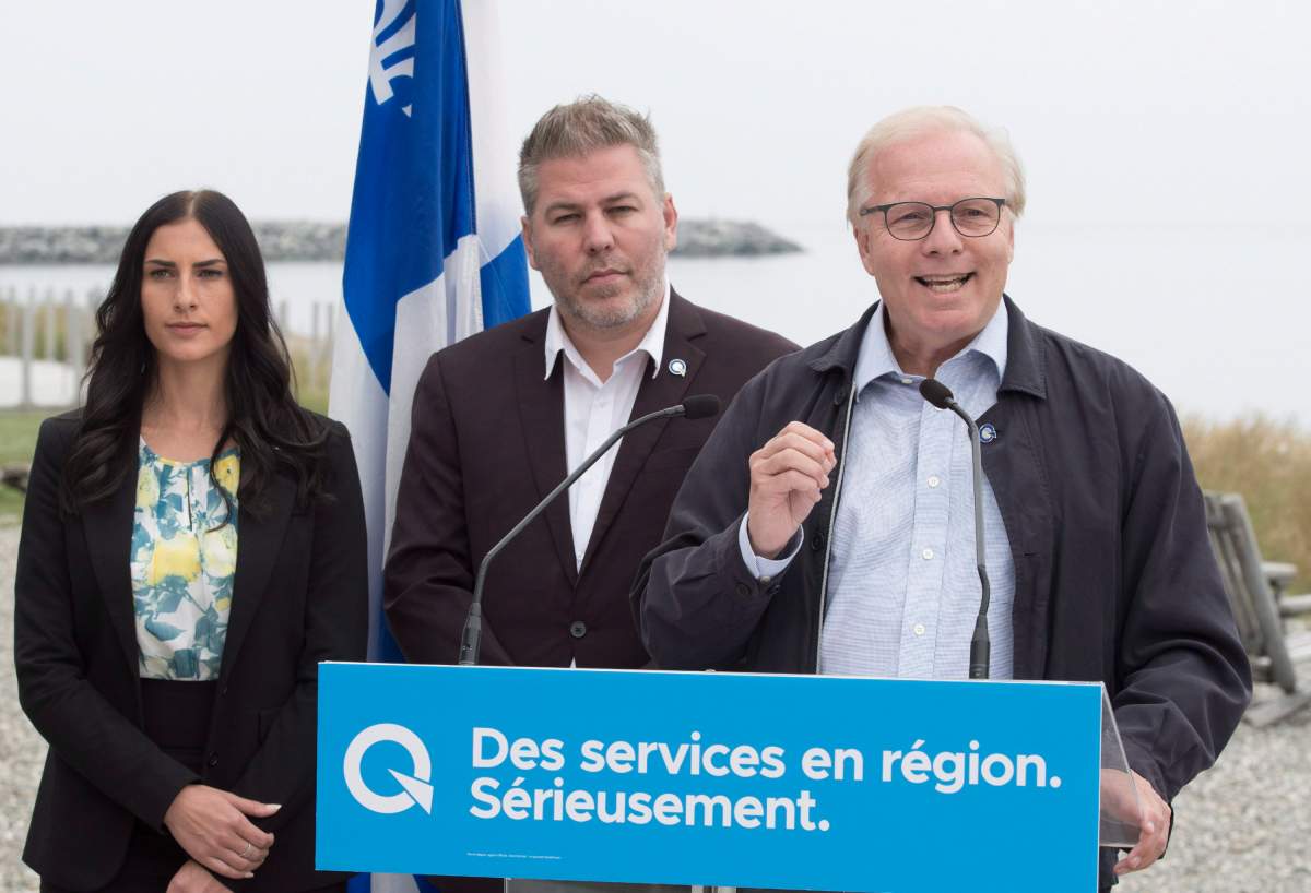 Parti Québécois Leader Jean-Francois Lisée, right, speaks at a news conference Monday, September 3, 2018 in Matane Que. Candidates Megane Perry-Melancon, left and Pascal Berubé, centre, look on.
