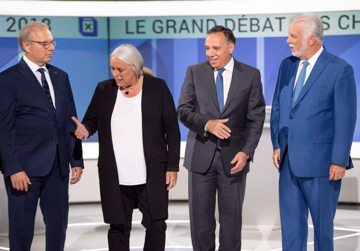 PQ leader Jean-François Lisée left, Quebec Solidaire leader Manon Massé , CAQ leader François Legault and Liberal leader Philippe Couillard , pose for photos before their debate Thursday, September 13, 2018 in Montreal, Que.