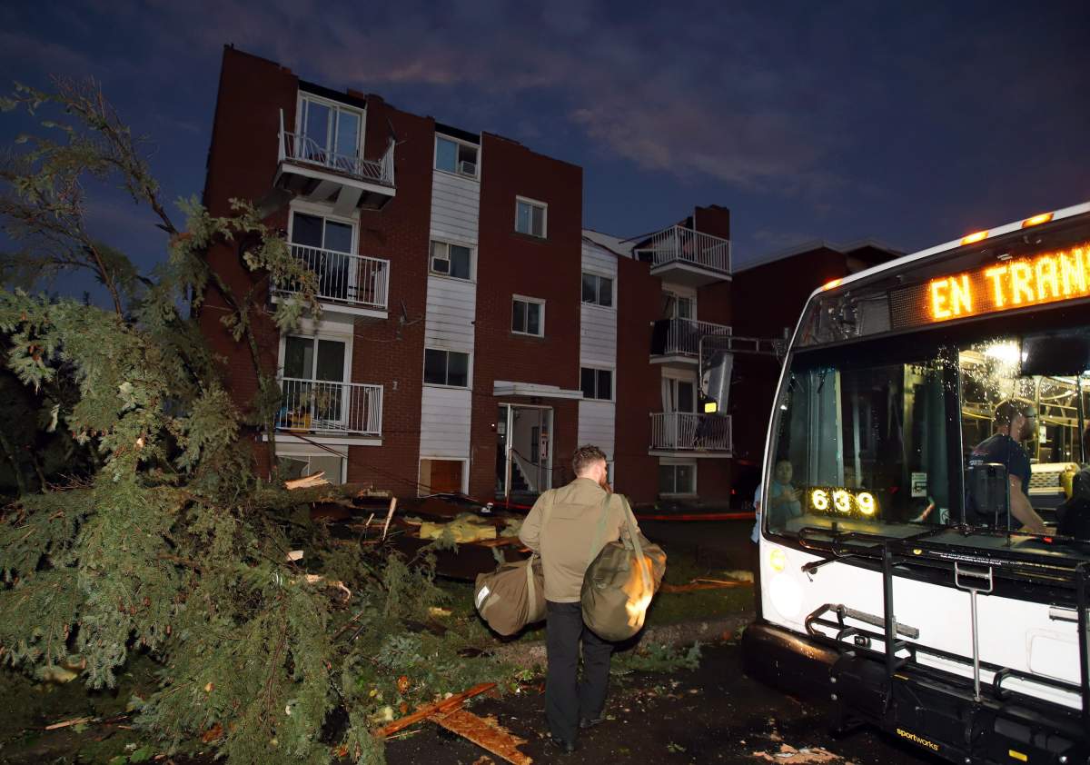 Residents board buses after apartment buildings had roofs torn off and windows blown out after a tornado caused extensive damage to a Gatineau, Quebec neighbourhood forcing hundreds of families to evacuate their homes on Friday, September 21, 2018. 
