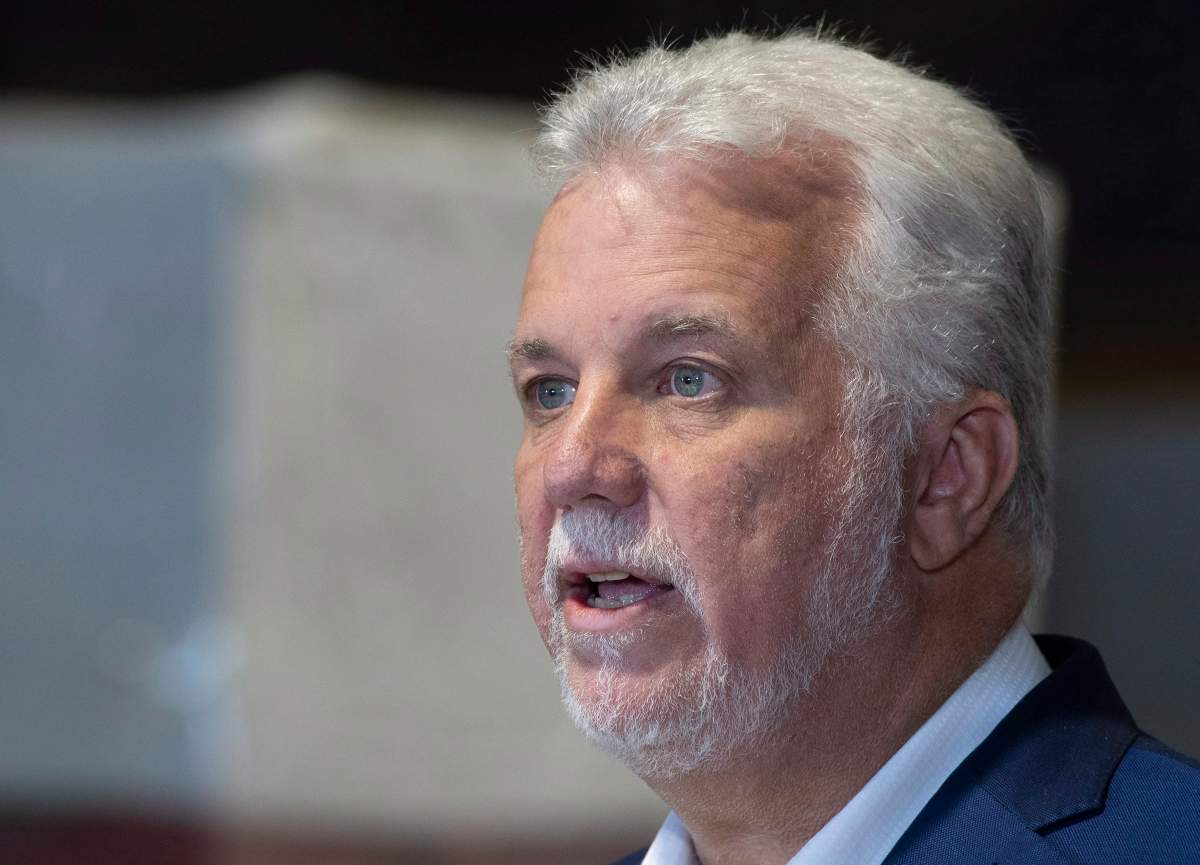 Quebec Liberal Leader Philippe Couillard responds to reporters questions during a visit of a cedar shingle plant in Saint-Prosper, Que., Thursday, Sept. 27, 2018. 