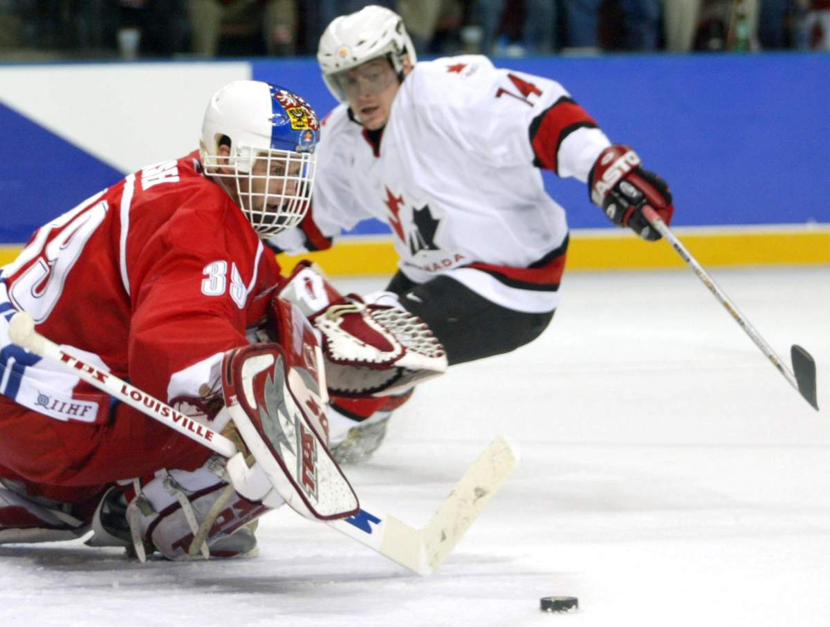 Czech Republic goalie Dominik Hasek makes the save on Canada’s Theo Fleury during third period hockey competition at the XIX Olympic Winter Games in Salt Lake City, Utah, Monday Feb 18, 2002.