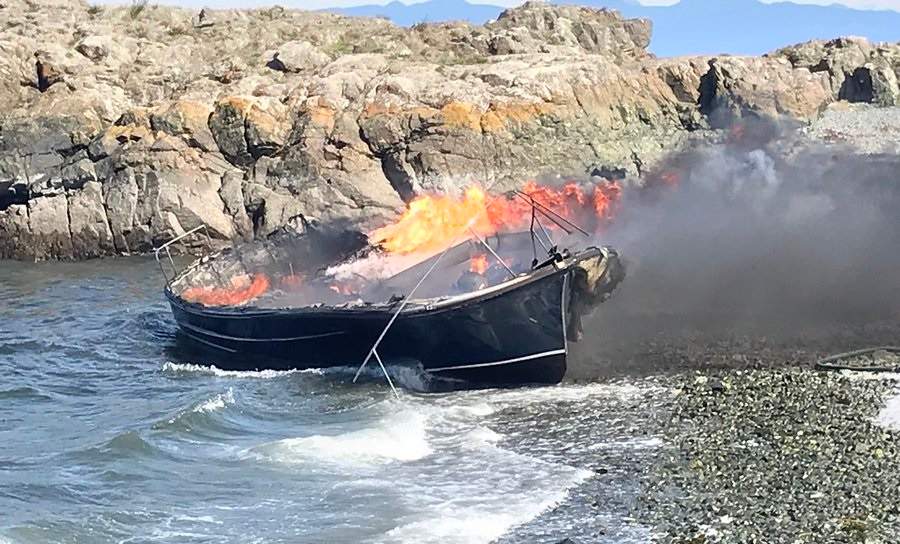 Three people were rescued from the waters off Nanaimo after this boat caught fire on Thursday.