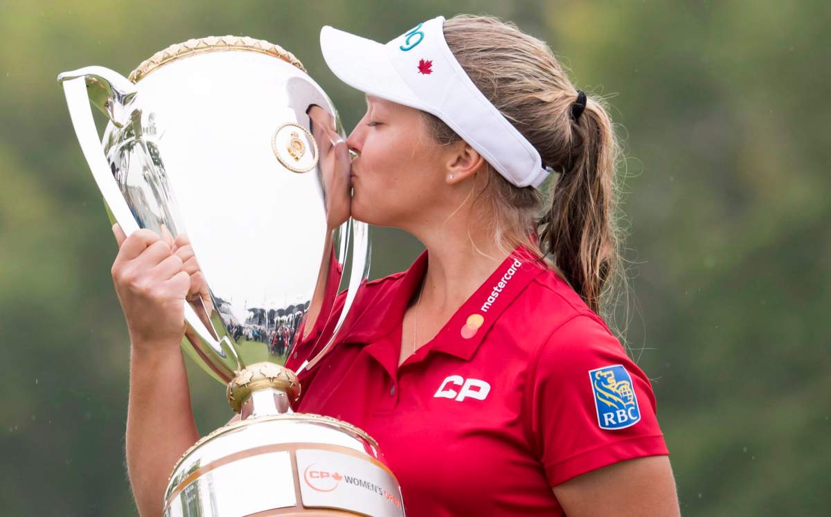 Brooke Henderson of Smiths Falls, ON kisses the trophy after winning the CP Women's Open in Regina, Sunday, August 26, 2018.