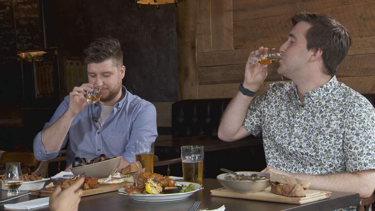 Luke and Aaron Green take a sip of whiskey.