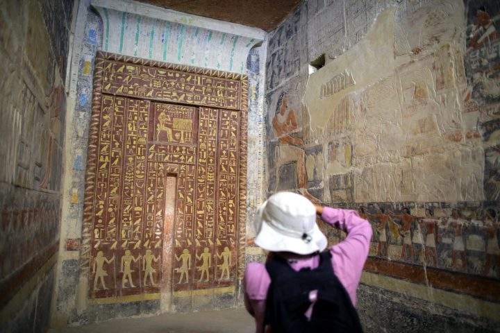 A photographer shoots inside one of the chambers of the tomb of Mehu, after it was opened for tourists at Saqqara area, Giza, Egypt, Sept. 8, 2018.