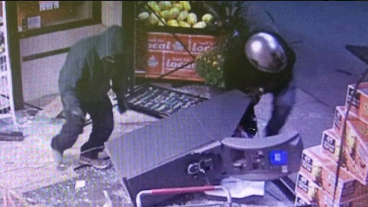 OPP Police allege at least three suspects, one of whom was wearing a helmet with a face shield, dragged a bank machine out of a store in Erin and made off with it.