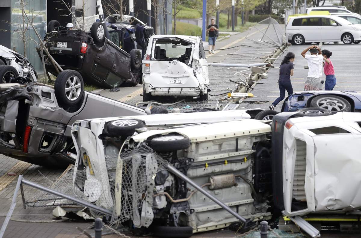 Photo shows motor vehicles blown over by winds from powerful Typhoon Jebi in Osaka, western Japan, on Sept. 4, 2018.