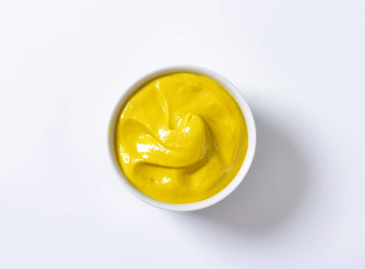 A restaurant in New York City serves pizza with mustard instead of tomato sauce. Would you try it?.