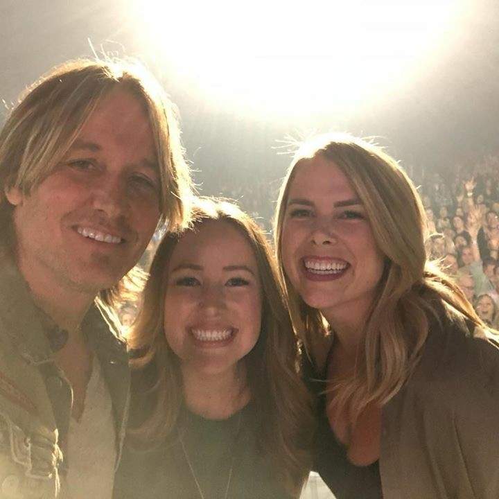 The coworkers take a selfie with Kieth Urban while on stage.