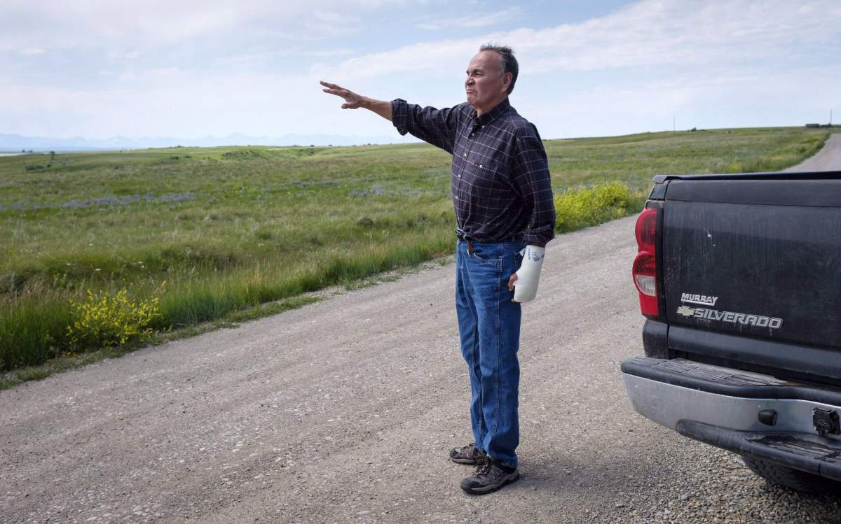 Former Blood Tribe Chief Harley Frank gestures from his truck on disputed land near his home near Spring Coulee, Alta. Thursday, July 5, 2018. 