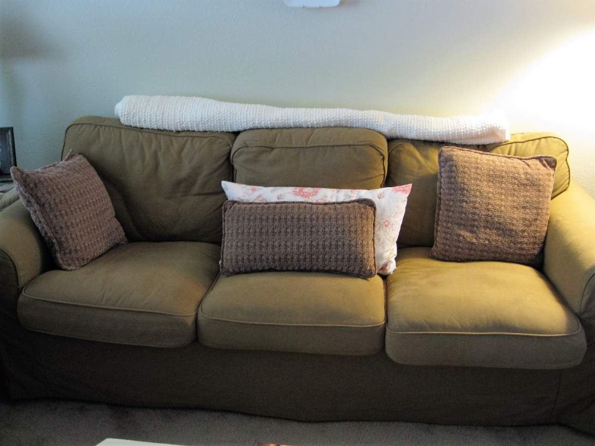 A female suspect managed to hide in the back of a couch before being spotted, said police.