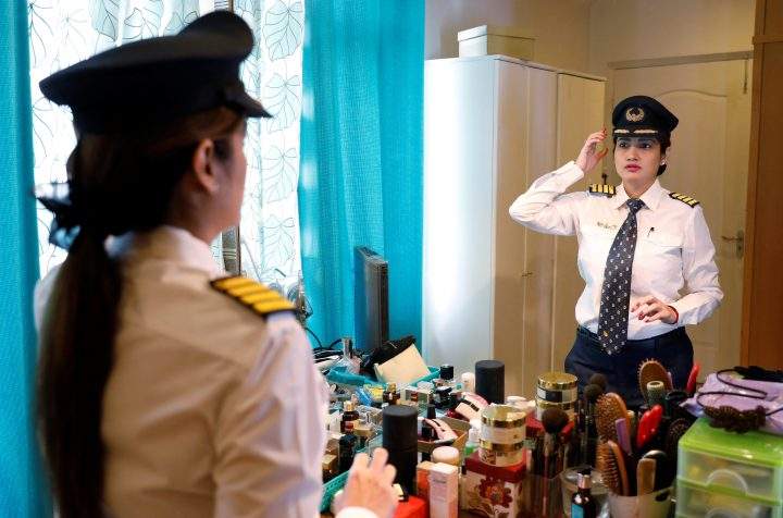 Shweta Singh, a Jet Airways pilot, gets ready inside her house in Gurugram, India, September 3, 2018.
