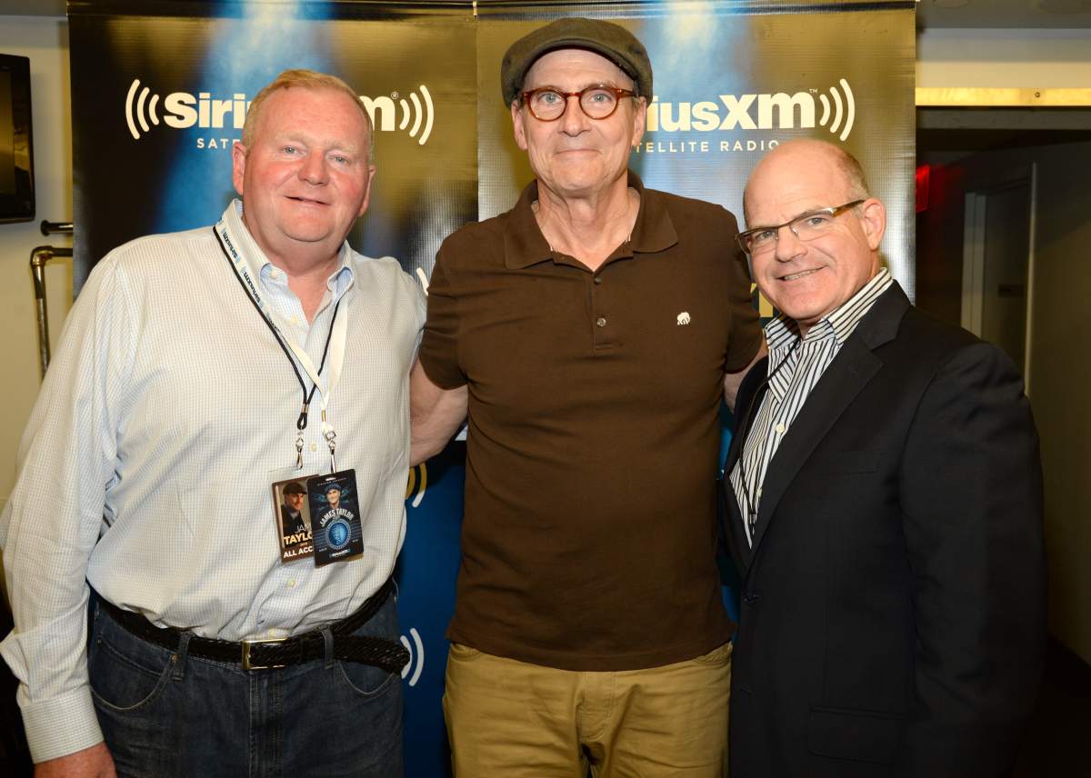 (L-R) SiriusXM CEO, Jim Meyer, James Taylor and President/CCO Scott Greenstein pose backstage during SiriusXM Presents James Taylor Live at The Apollo Theater.