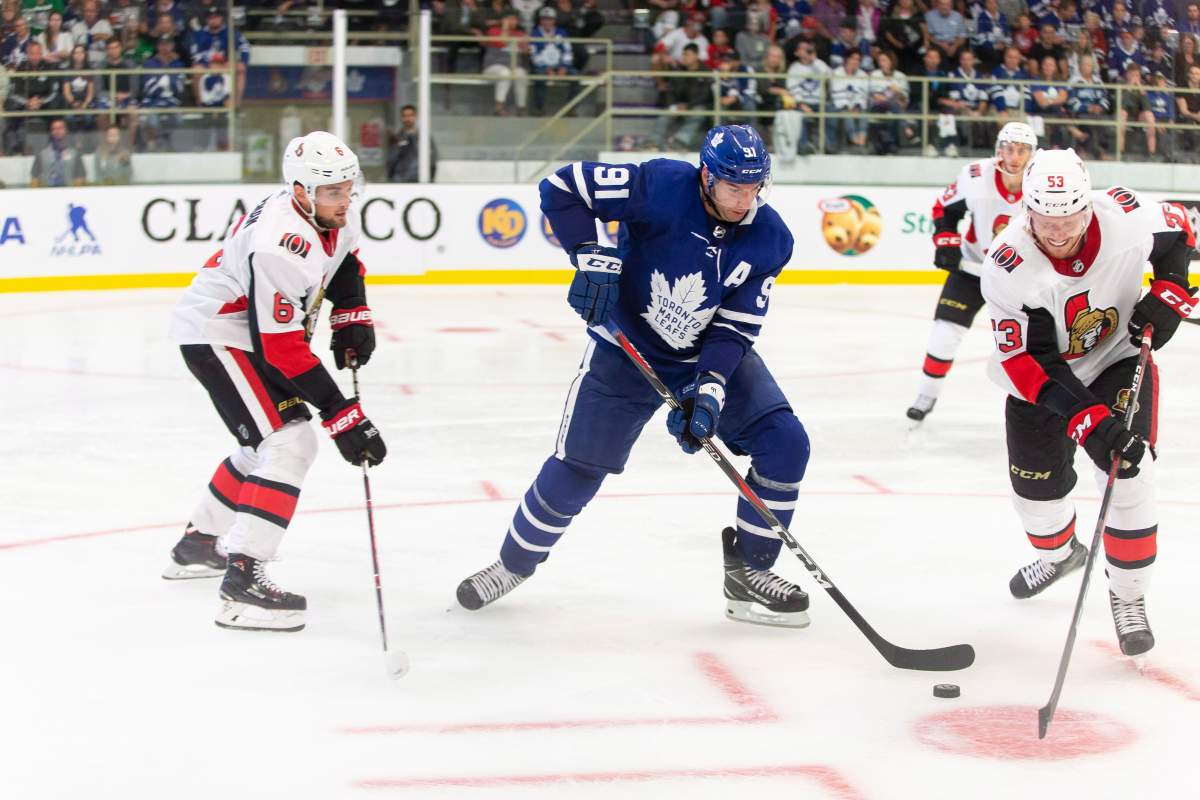 Toronto's John Tavares fights for the puck with Ottawa's Jack Rodewald during the second period of the NHL pre-season game between the Maple Leafs and the Senators in Lucan, Ont., Tuesday, Sept. 18, 2018.