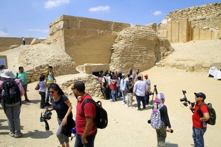People wait outside one of the chambers of the tomb of Mehu, after it was opened for tourists at Saqqara area, Giza, Egypt, Sept. 8, 2018.