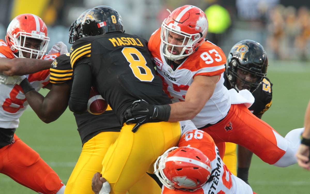 Lions' Craig Roh gets to  Ticats' quarterback Jeremiah Masoli during second quarter CFL action in Hamilton on Friday, July 1st, 2016. 